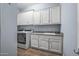 Laundry room with washer, dryer, cabinets, and shelving at 18852 N 260Th Ln, Buckeye, AZ 85396