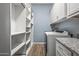 Bright laundry room with storage and modern appliances at 18852 N 260Th Ln, Buckeye, AZ 85396