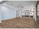 Living area with hardwood floors, fireplace, and built-in shelving at 18852 N 260Th Ln, Buckeye, AZ 85396