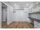 Spacious office with a Murphy bed, built-in shelving and a desk at 18852 N 260Th Ln, Buckeye, AZ 85396
