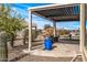 Covered patio with pergola, fountain, and potted plants at 18852 N 260Th Ln, Buckeye, AZ 85396