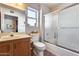 Clean bathroom with a shower/tub combo and wood vanity at 21605 N 147Th Dr, Sun City West, AZ 85375