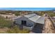 Aerial view of a barn with metal roof and surrounding landscape at 26620 N 141St St, Scottsdale, AZ 85262