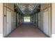 Long barn aisle with multiple horse stalls at 26620 N 141St St, Scottsdale, AZ 85262