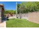 Landscaped backyard with artificial turf,cactus, and stone walls at 2671 S Moonlight Dr, Gold Canyon, AZ 85118