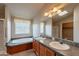Bathroom features double sinks, an oval tub, and a separate shower at 3301 S Goldfield Rd # 2015, Apache Junction, AZ 85119