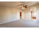 Spacious carpeted bedroom with ceiling fan and ensuite bathroom access at 3301 S Goldfield Rd # 2015, Apache Junction, AZ 85119