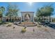 Elegant community clubhouse entrance with a fountain and landscaping at 3301 S Goldfield Rd # 2015, Apache Junction, AZ 85119