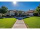 Building exterior with covered patio and lush green lawn at 3301 S Goldfield Rd # 2015, Apache Junction, AZ 85119