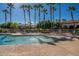 Inviting community pool with plenty of lounge chairs and umbrellas at 3301 S Goldfield Rd # 2015, Apache Junction, AZ 85119