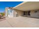 Covered patio with screen door and desert landscaping at 3301 S Goldfield Rd # 2015, Apache Junction, AZ 85119