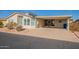 Tan single story home with carport and desert landscaping at 3301 S Goldfield Rd # 2015, Apache Junction, AZ 85119