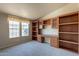Home office with built-in wooden desk and shelving at 3301 S Goldfield Rd # 2015, Apache Junction, AZ 85119