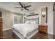 Spacious main bedroom with a king-size bed, ceiling fan, and wood floors at 3500 N Hayden Rd # 1306, Scottsdale, AZ 85251