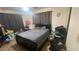 Small bedroom with double bed and dark curtains at 3818 W Rose Ln, Phoenix, AZ 85019