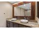 Double vanity bathroom with granite countertop and large mirror at 4200 N Miller Rd # 408, Scottsdale, AZ 85251