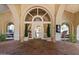 Building entrance with arched doorway and brick flooring at 4200 N Miller Rd # 408, Scottsdale, AZ 85251