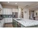 Modern kitchen with green island, granite countertops, and stainless steel appliances at 5167 N 183Rd Dr, Litchfield Park, AZ 85340