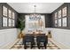 Spacious home office with wood desk, dark-colored walls, and a chic light fixture at 7431 W Whitehorn Trl, Peoria, AZ 85383