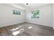 Well-lit bedroom featuring hardwood floors and two windows at 1010 W Oregon Ave, Phoenix, AZ 85013