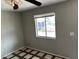 Simple bedroom with tile flooring and window at 14210 N Primrose St, El Mirage, AZ 85335