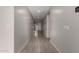 Bright hallway with gray walls and wood-look tile floors at 18056 W Wolf St, Goodyear, AZ 85395