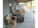 Covered patio with wooden furniture and grill at 20165 W Moccasin Trl, Buckeye, AZ 85326