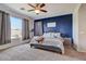 Main bedroom with large window, ceiling fan and ensuite bathroom at 22 E Mill Reef Dr, San Tan Valley, AZ 85143