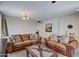 Comfortable living room with leather sofas, a coffee table, and neutral decor at 22 E Mill Reef Dr, San Tan Valley, AZ 85143