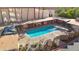 Aerial view of a rectangular swimming pool with surrounding patio furniture and landscaping at 2201 N Central Ave # 6F, Phoenix, AZ 85004