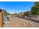 Spacious backyard with gravel, mature trees, and a small garden area at 2261 N Demaret Dr, Mesa, AZ 85215