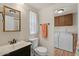 Bathroom with toilet, sink, and laundry appliances at 2261 N Demaret Dr, Mesa, AZ 85215