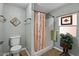 Bathroom with toilet, shower, and decorative curtain at 2261 N Demaret Dr, Mesa, AZ 85215