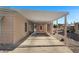Covered carport with concrete flooring and access to the house at 2261 N Demaret Dr, Mesa, AZ 85215