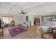 Open living room with hardwood floors, multiple seating areas and view to kitchen at 2261 N Demaret Dr, Mesa, AZ 85215