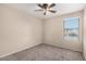 Charming bedroom with a ceiling fan and large window at 23582 W Wier Ave, Buckeye, AZ 85326