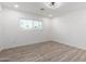 Bright bedroom featuring wood-look floors and a window with blinds at 5534 N 42Nd Ln, Phoenix, AZ 85019