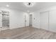 Well-lit bedroom with wood-look floors and an ensuite bathroom at 5534 N 42Nd Ln, Phoenix, AZ 85019