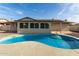 Kidney-shaped pool with concrete decking in the backyard at 5534 N 42Nd Ln, Phoenix, AZ 85019