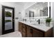 Modern bathroom with double vanity, a large mirror, and stylish finishes at 8508 E Mustang Trl, Scottsdale, AZ 85258
