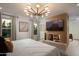Luxurious bedroom featuring a large bed and a fireplace at 8508 E Mustang Trl, Scottsdale, AZ 85258