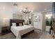 Bright bedroom with a large bed, artwork and chandelier at 8508 E Mustang Trl, Scottsdale, AZ 85258