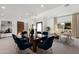 Formal dining area with a glass table and navy blue velvet chairs at 8508 E Mustang Trl, Scottsdale, AZ 85258