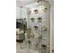 Modern glass-enclosed wine cellar with a sleek, stone wall design at 8508 E Mustang Trl, Scottsdale, AZ 85258