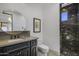 Bathroom with dark vanity, granite shower, and round mirror at 9732 N Fireridge Trl, Fountain Hills, AZ 85268