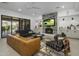 Open living area with stone fireplace, large TV, and access to backyard patio at 9732 N Fireridge Trl, Fountain Hills, AZ 85268