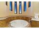 Relax in this large, circular soaking tub, surrounded by windows at 9782 E Troon North Dr, Scottsdale, AZ 85262