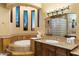 Spa-like bathroom with a large soaking tub, walk-in shower, and dual vanities at 9782 E Troon North Dr, Scottsdale, AZ 85262