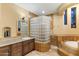 Bathroom with a glass-block shower, soaking tub, and granite countertops at 9782 E Troon North Dr, Scottsdale, AZ 85262