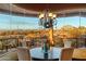 Elegant dining room with scenic views and a large chandelier at 9782 E Troon North Dr, Scottsdale, AZ 85262